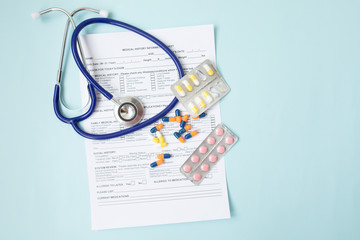 Pharmacy background. Tablets on a blue background. Pills. Medicine and healthy. Close up of capsules. Stethoscope on a blur paper background. Copy space for a text.