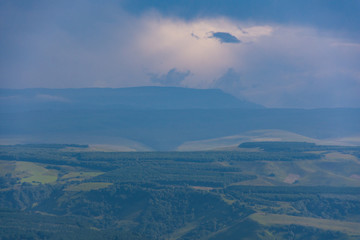 Overcast clouds in the distance over the hills