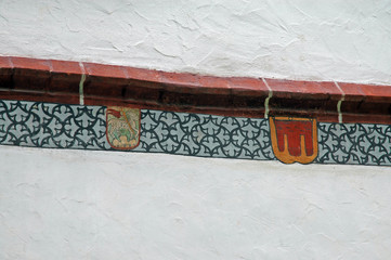 border at medival building with coat of arms