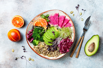 Vegan, detox Buddha bowl with quinoa, micro greens, avocado, blood orange, broccoli, watermelon...