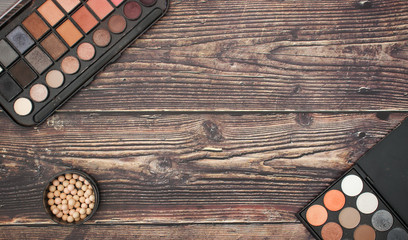 Cosmetics and make up products on wooden background