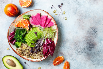 Vegan, detox Buddha bowl with quinoa, micro greens, avocado, blood orange, broccoli, watermelon...