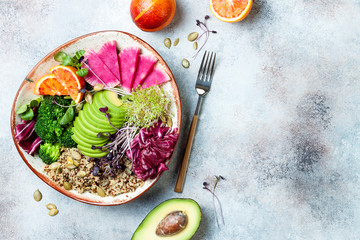 Vegan, detox Buddha bowl with quinoa, micro greens, avocado, blood orange, broccoli, watermelon...