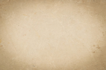 The texture of the surface of the old brown cardboard. Vignette effect. Empty and shabby background.	