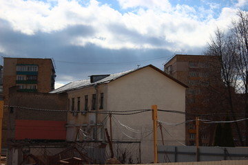 the destruction of the old building, reconstruction, structural changes. construction, high-rise crane works on the site. the building is made of brick, tiles on the walls. 