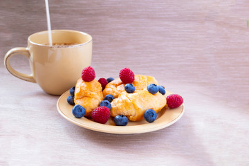 fresh juicy summer berries raspberry and blueberry with drops of honey in a natural beige cotton cloth. 