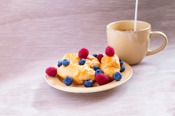 fresh juicy summer berries raspberry and blueberry with drops of honey in a natural beige cotton cloth. 