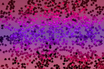 Holographic hearts on trendy pink, purple, red background. Festive backdrop. Top view.