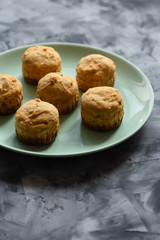 Diet and healthy dessert concept. Sugar free muffins in green plate on dark background