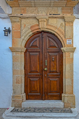Fototapeta na wymiar Wooden door in traditional Greek house in historic village of Lindos on Rhodes island. Greece.