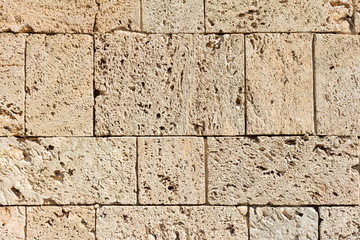 Sandstone brick wall on sunshine texture