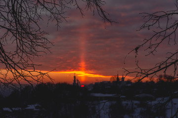 Obraz premium Light pole from the sun at sunset over the temple in Vladimir in winter