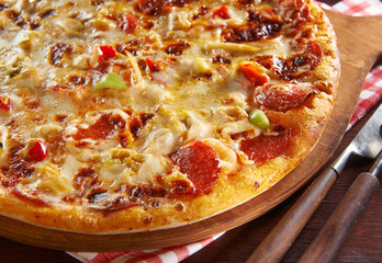 Fresh pizza on wooden table with ingredients