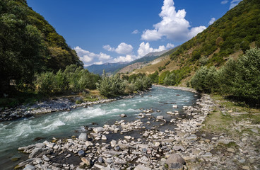 Fast mountain river. Summer landscape in mountains. Gorge in Caucasus Mountains. Georgia.