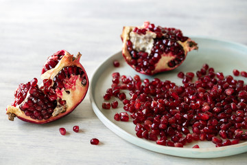 Ripe open pomegranate and seeds on white background 