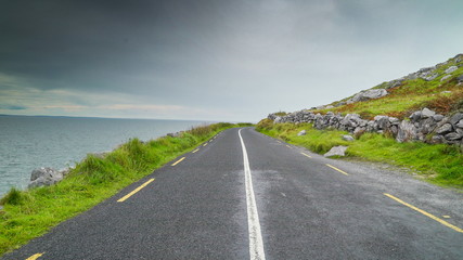11381_The_long_road_going_through_the_coastal_area_in_Ireland_in_Ireland.jpg