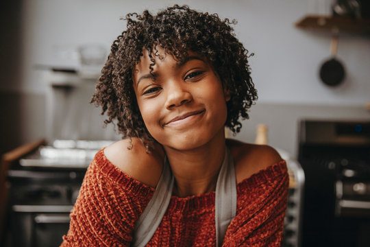 Portrait of smiling teenage girl in kitchen