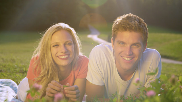 PORTRAIT: Cheerful Caucasian couple films a v-log in the idyllic sunny nature.