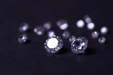 Foto op Canvas Scattering of white star diamonds on black background table jeweler concept © Bugaev