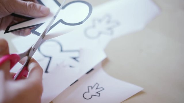 scissors cutting different paper silhouettes for April fools day 