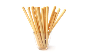 Bread sticks isolated on white background. Crunchy bread sticks in glass cup.