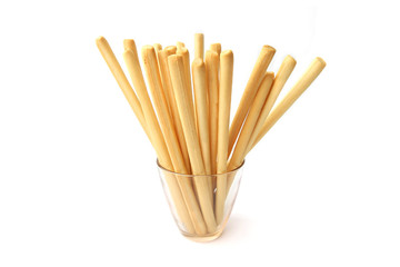 Bread sticks isolated on white background. Crunchy bread sticks in glass cup.