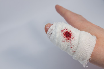 a finger in bloody bandage