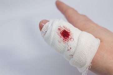a finger in bloody bandage