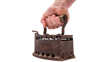 Hand holds old rusty iron on a white background. Ironing