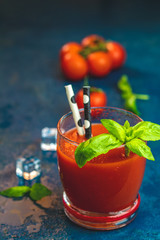 Delicious tomato bloody mary cocktail on dark blue concrete table