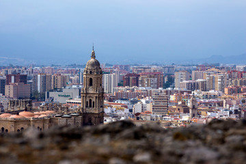 Obraz premium Malaga, Spain, February 2019. Panorama of the Spanish city of Malaga. Cathedral of Malaga. Buildings against a cloudy sky. Dramatic sky over the city. Beautiful view.