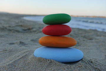 Fototapeta na wymiar Stack of colored stones on the beach
