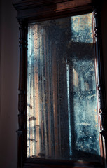 Antique cracked mirror with blurred abstract reflection. The concept of past time, memories. Retro background.