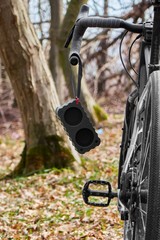Fototapeta na wymiar portable bluetooth speaker on a bicycle in the woods