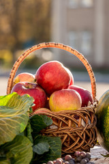 Red juicy apples in a wicker basket. Vertical_