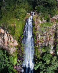 Fototapeta na wymiar Aerial view of a waterfall in the middle of the rainforest
