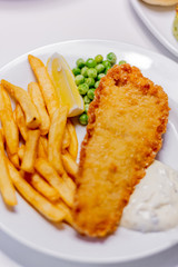 fried fish with french fries and vegetables