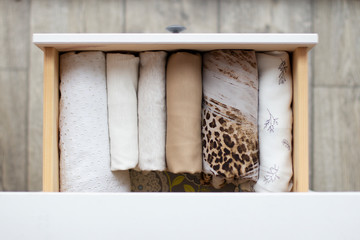 womens clothing white, beige and leopard adopted in the drawers of the chest of white color in daylight