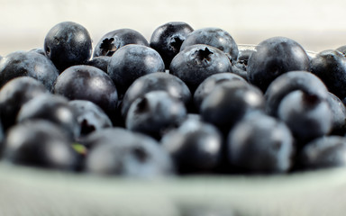 Blueberries in small bowl, closeup detailed photo