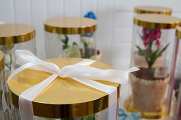 A beautiful chocolate cake at March 8 International Women's Day decorated with hyacinth, violet and rose from meringue.