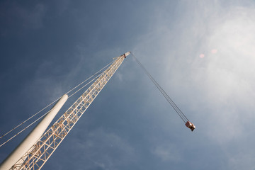 Building and assembling a construction windmill by a crane, The Netherlands. Blue sky