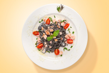 Italian squid ink pasta with salmon and parmesan cheese. Food from above