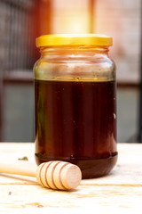 jar of  pure Honey and wooden dripper