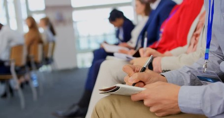 Business people writing on notepad in the business seminar 4k