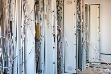 Relay hall with a variety of wires in the process of installation