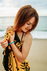 beautiful young girl in pareo walking on the sunset beach on sunlight in Philippines - Summer...