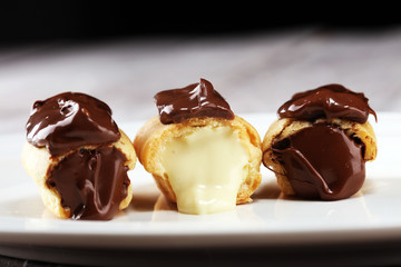 Traditional French dessert. Eclair with chocolate icing. Pastery concept with chocolate eclair