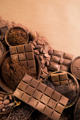 Cocoa beans and chocolate on natural paper background