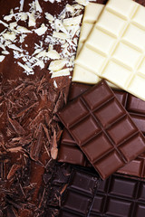 chocolate in diffrent color. milk, dark and white chocolate bars on table