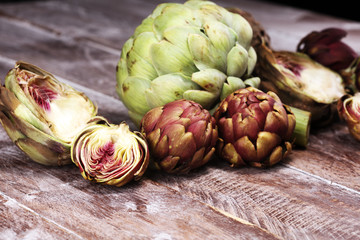 Fototapeta premium artichokes on grey background. fresh organic artichoke flower vegetable
